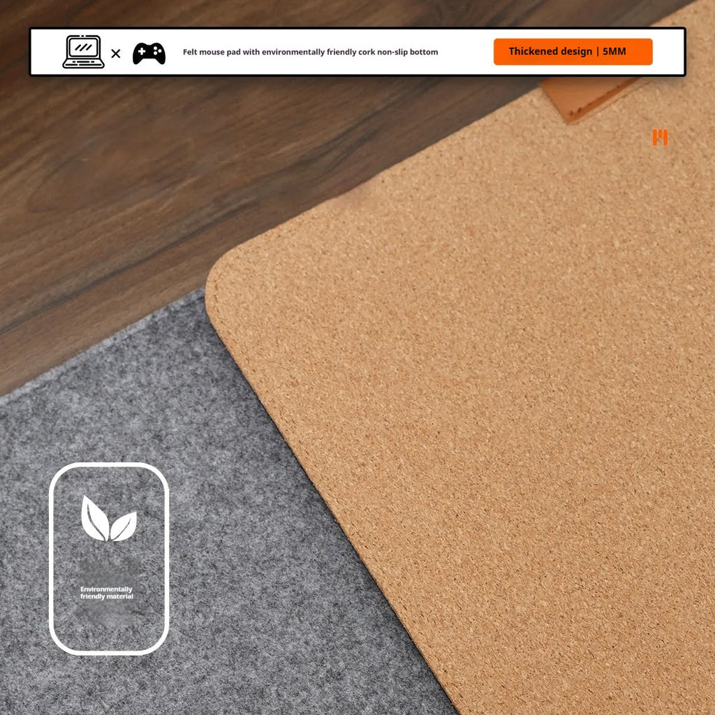 Oversized felt cork desk mouse mat in black and grey pattern, shown on a wooden desk.