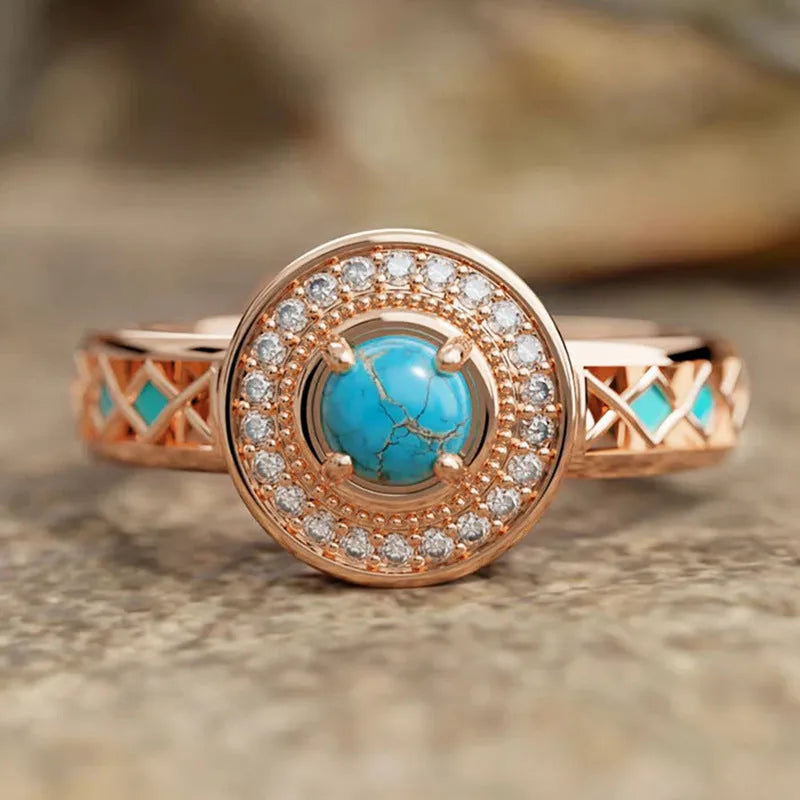 Women's rose gold coloured copper ring with geometric ethnic design and inlaid zircon detailing.