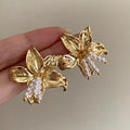 Gold H1795 metal floral earrings with detailed flower shape and niche style design
