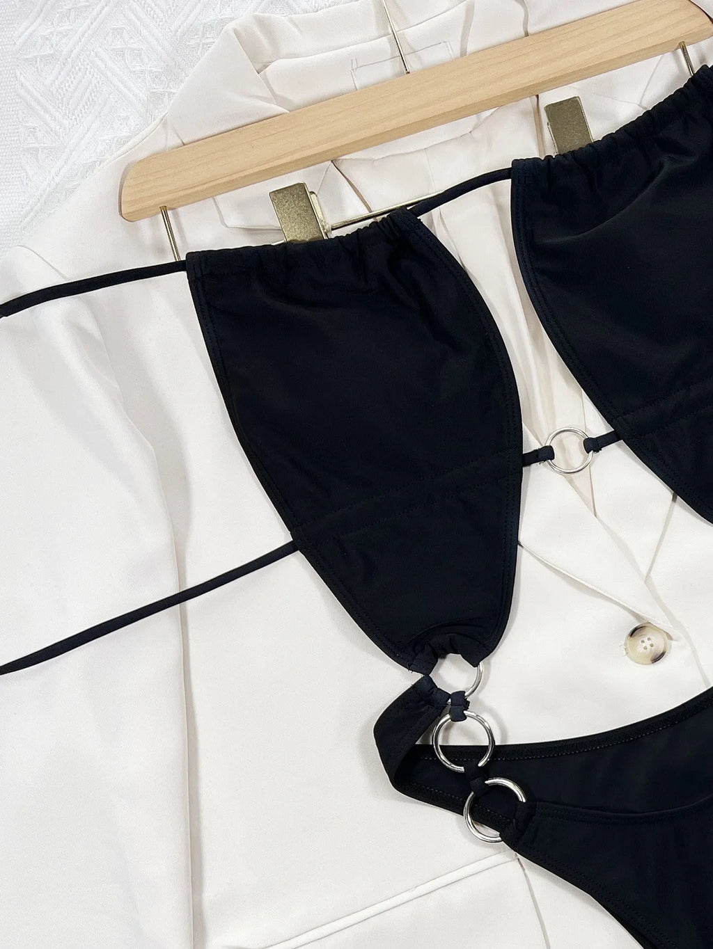 Black sleeveless one-piece swimming suit on a mannequin, front view.