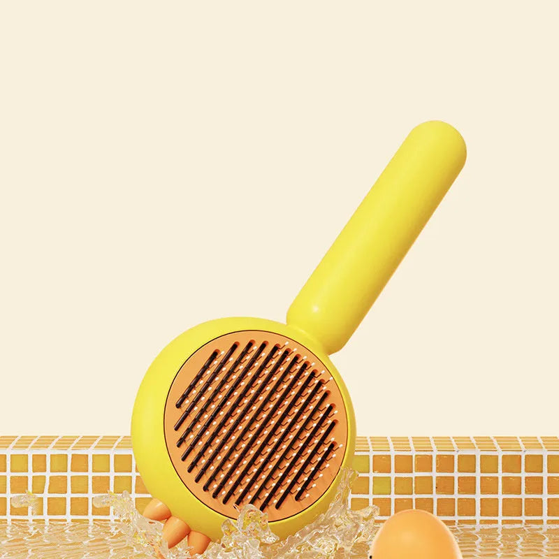 Purple pet grooming brush with stainless steel bristles and a self-cleaning button on a white background.
