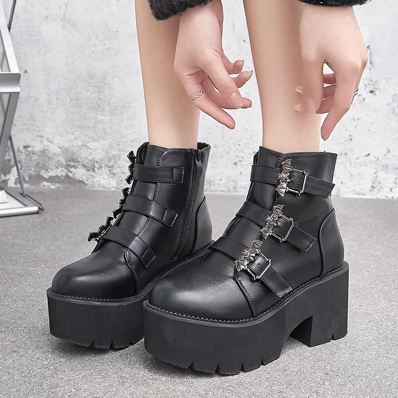 Black women's punk style Martin boots with bat buckle and side zip closure