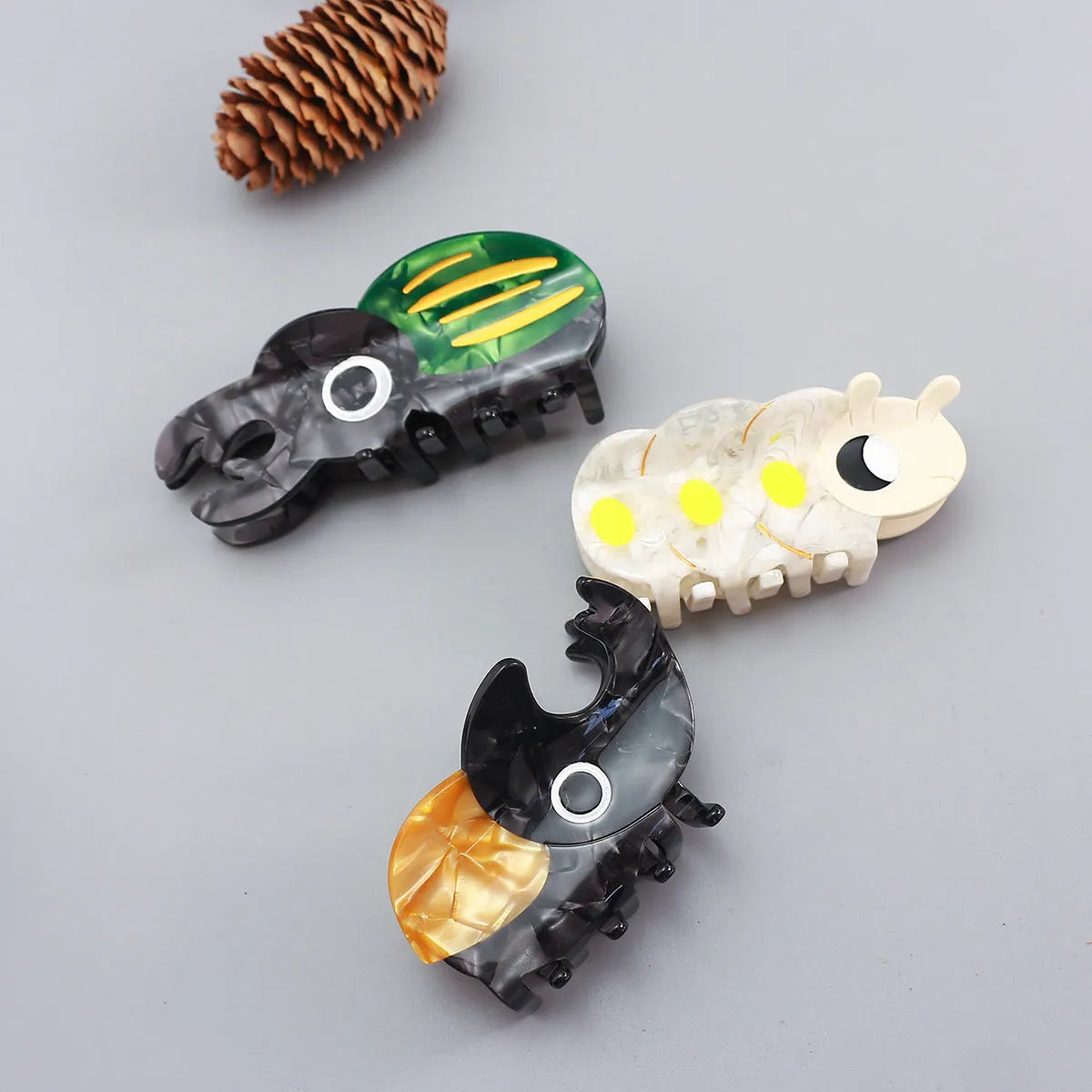Handmade cellulose acetate Beetle Grip with cartoon caterpillar design in green or orange beetle colours