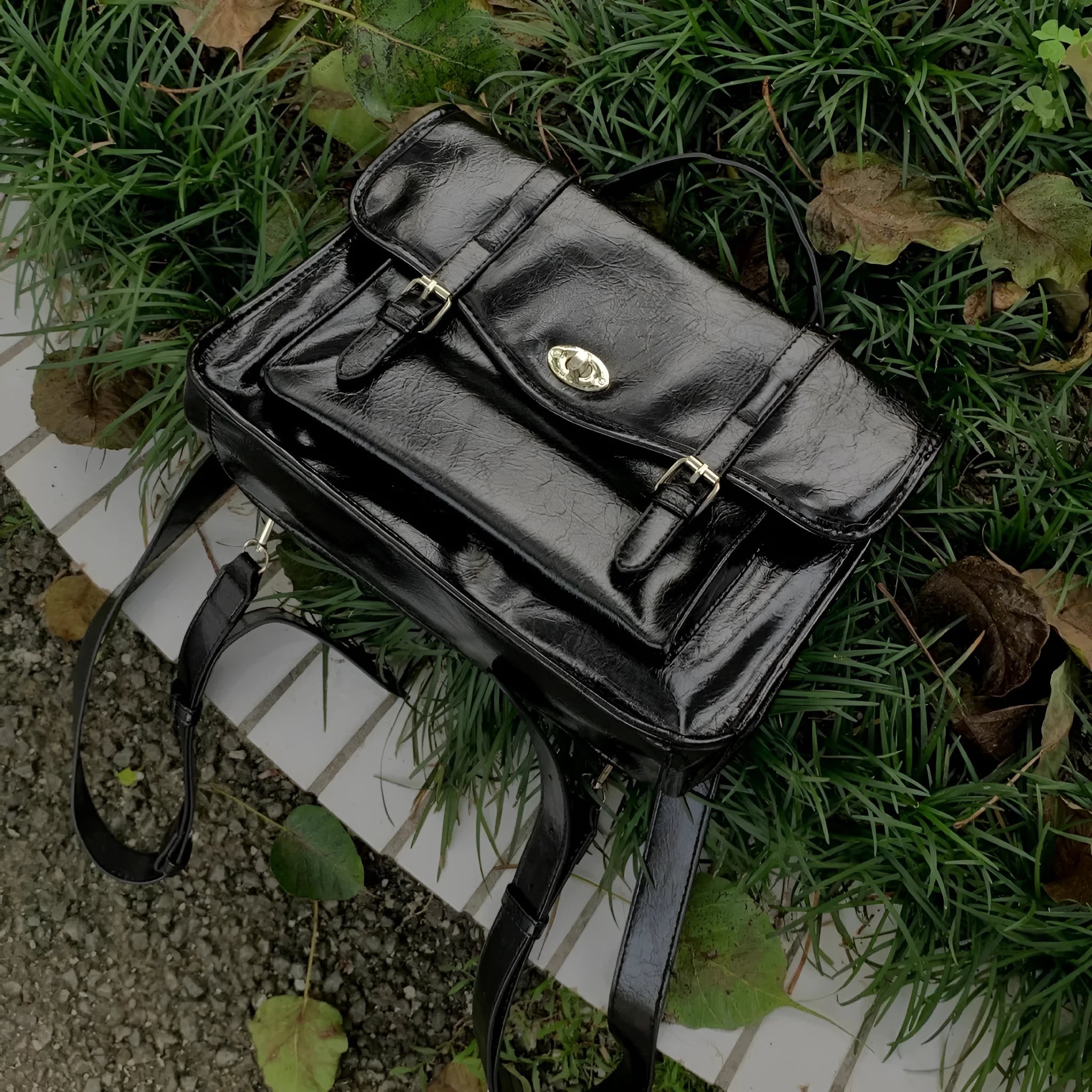 Women's black college style messenger bag made from oil wax PU leather showing front view