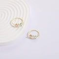 Geometric triangle ring with tricolour zircon birthstone in gold electroplated finish.
