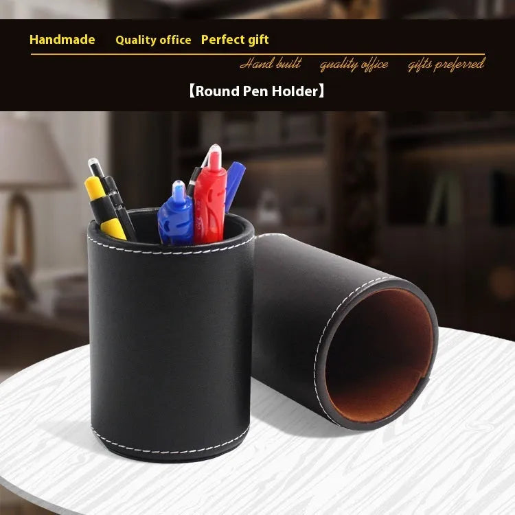 Black leather round pen holder with cylindrical shape on a desk