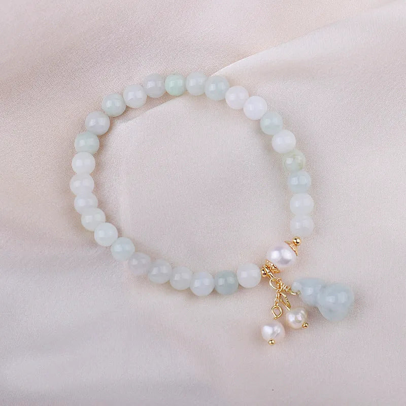 Emerald green jade bracelet with Chinese gourd design elements
