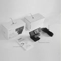 Matte black 4K USB webcam on a desk with a detached magnetic privacy cover and a long cable.