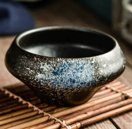 Ceramic tall Japanese soup noodle bowl in a retro glaze colour on a wooden table.