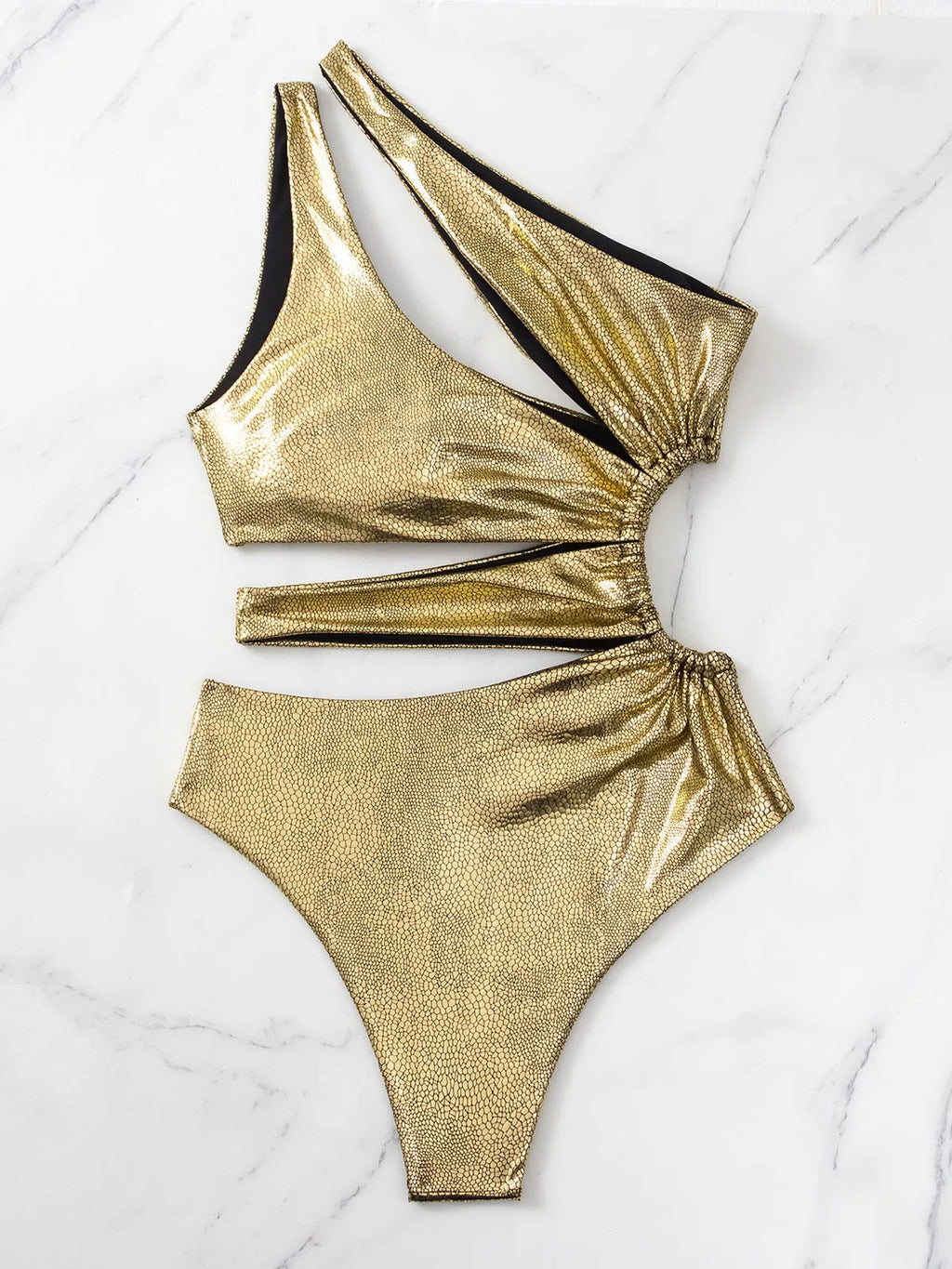 Women's gold backless one-piece swimsuit on a white background