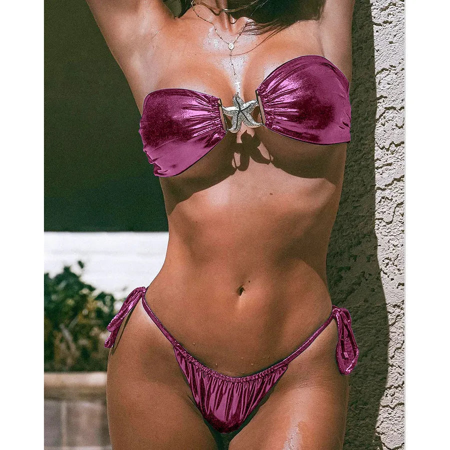 Women's glossy sapphire blue bikini set with gold starfish print on tube top and briefs.