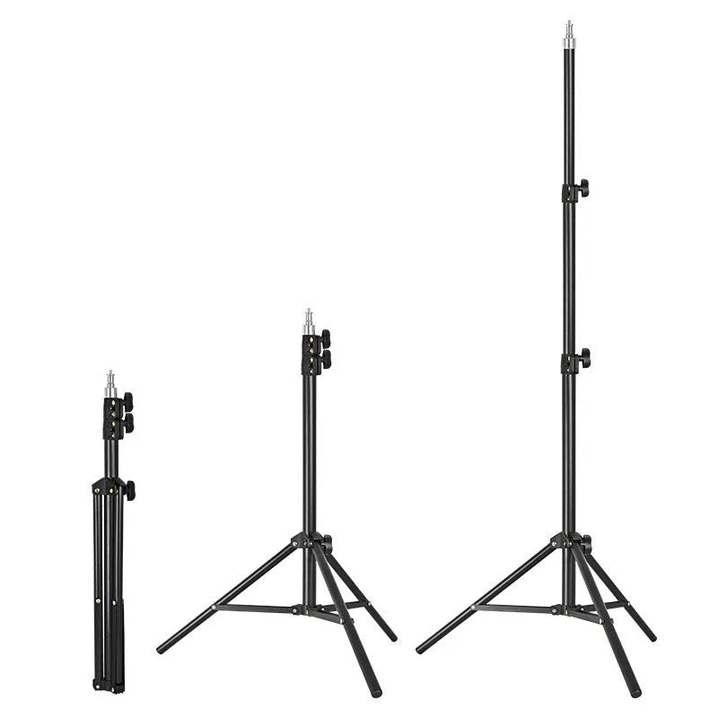 A frosted finish floor tripod light stand at full height with a mobile phone holder attached.