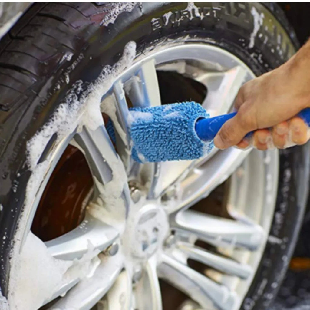 Blue long-handled microfiber brush for cleaning car tyres and wheels on a grey background.