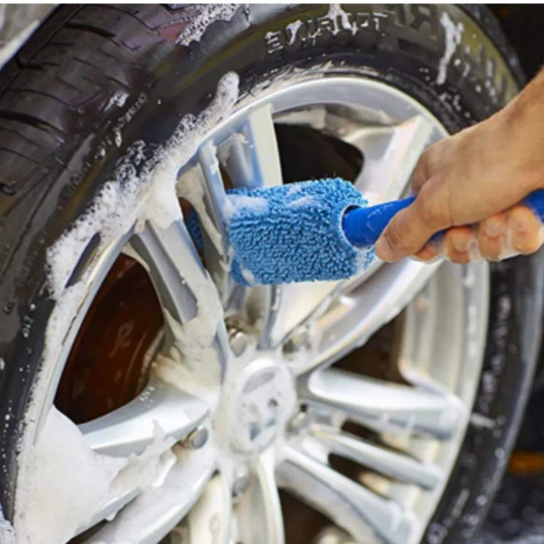 Blue long-handled microfiber brush for cleaning car tyres and wheels on a grey background.
