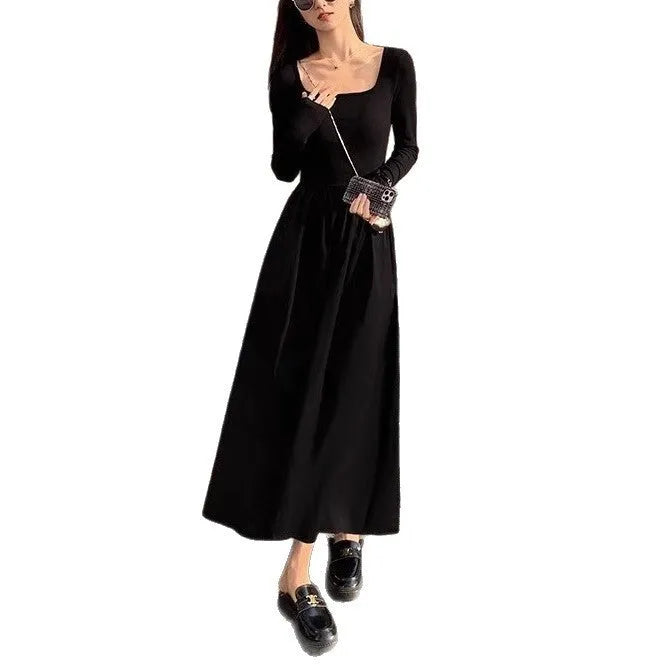 Women's black knitted dress with square collar, long sleeves, elastic waist, and A-line skirt.