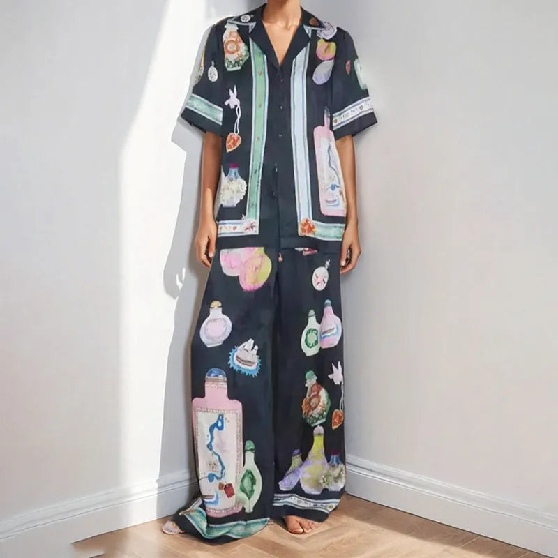 Women's black cartoon pattern holiday fashion set with trousers and cardigan-style top