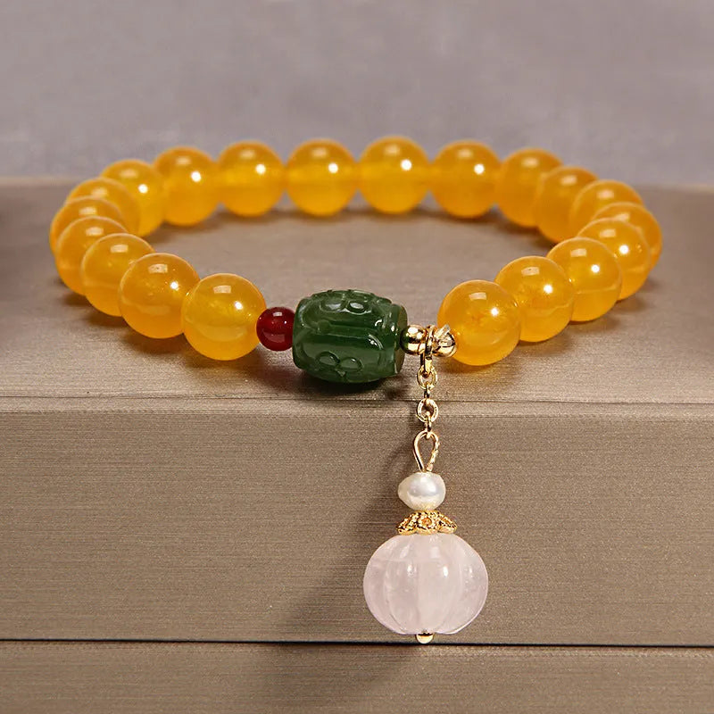 Khaki coloured crystal bead bracelet for women on a gold silk cord, showing Japanese and South Korean style.