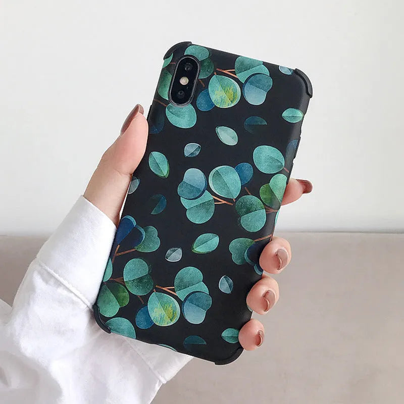 Black silicone iPhone case with a raised leaf pattern design on the back.