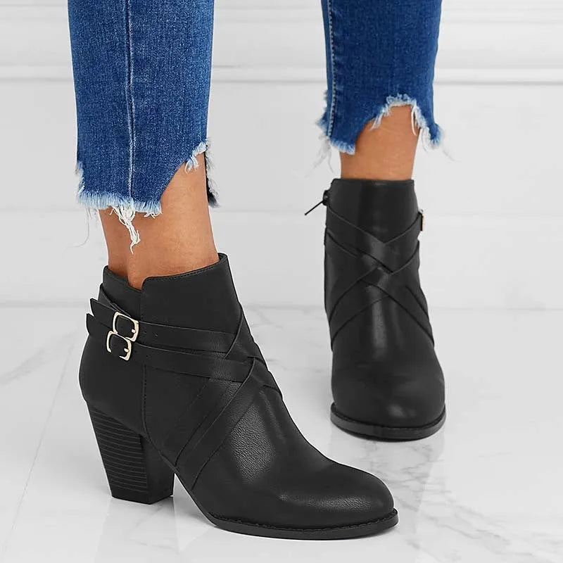 Grey plus-size short boot with 7cm heel, side zip, and buckle detail on a wooden floor