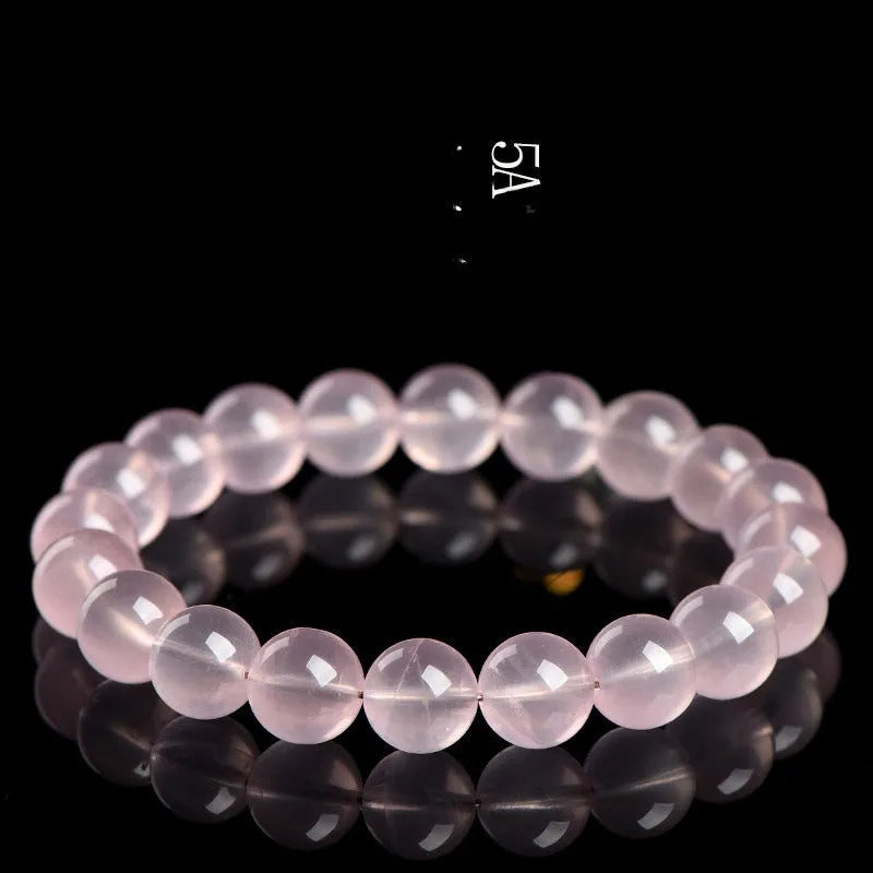 Natural Starlight Crystal round bead bracelet in pink, showing polished finish on wrist.