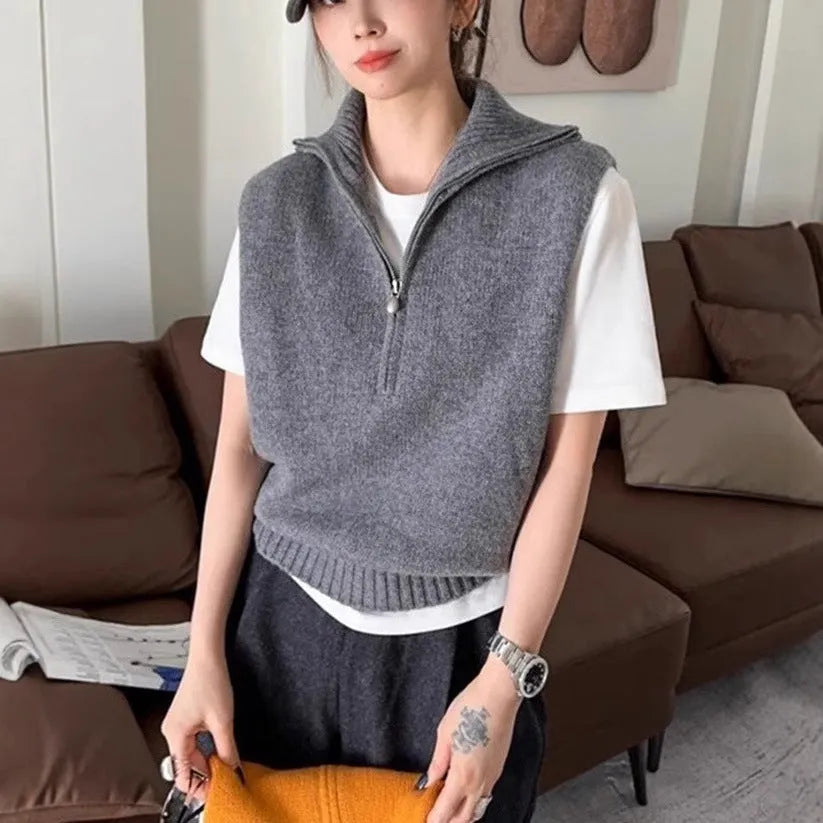 Orange sleeveless half-zip mesh knit vest on a hanger, casual style.