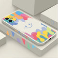 White TPU iPhone case with rainbow smiley faces on top and bottom, includes a black lanyard.