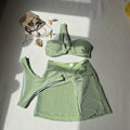 Women's one-shoulder tube top three-piece swimsuit set in glossy polyester, shown in light green.