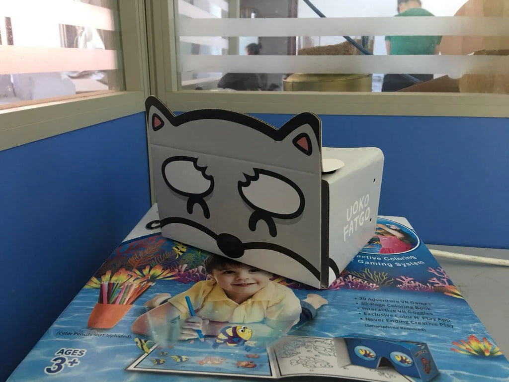 Flat-pack DIY VR cardboard glasses kit for 6-inch smartphones with 3D lenses, rubber band, and velcro strap.