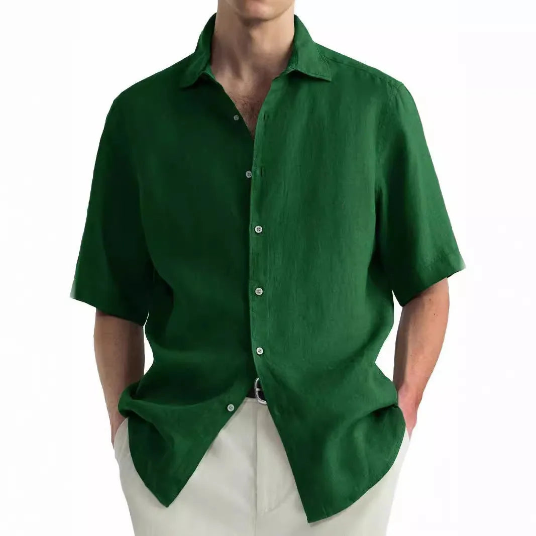 Man wearing a green washed cotton casual shirt in a regular fit, available with matching trousers.
