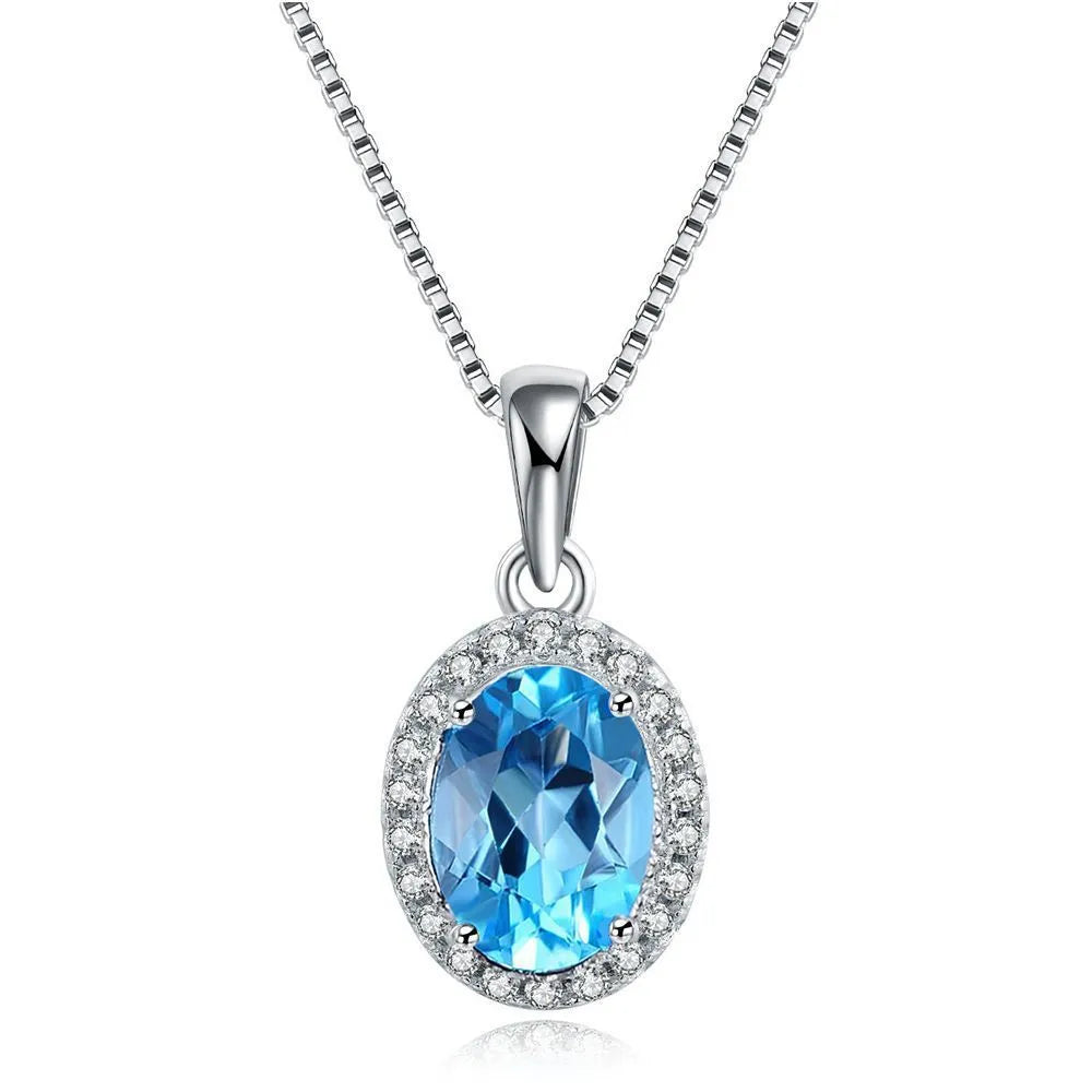 925 sterling silver jewellery set with blue topaz gemstones showing geometric design earrings, ring, pendant, and necklace