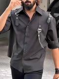 A man's black utility-style button-up shirt with a regular fit, made from polyester fabric.