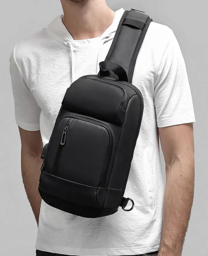 Black PVC outdoor shoulder bag with air cushion strap showing internal laptop and phone compartments