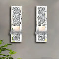 A pair of tall silver mirror glass candle holders designed for wall mounting
