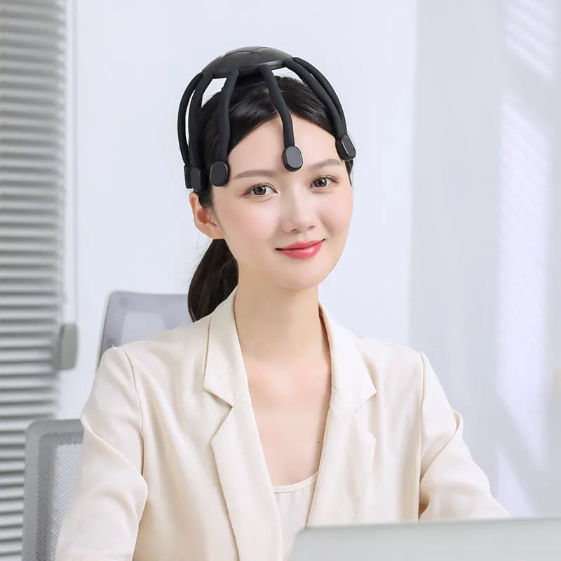 Black or white USB head massager with multiple vibrating claws for scalp relaxation.