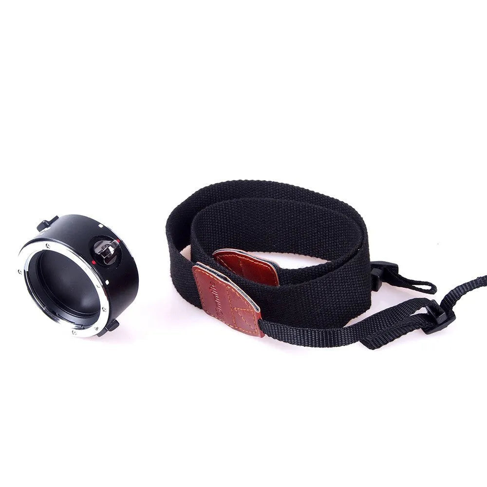 Aluminium camera lens flipper holder with cotton strap for quick lens changes on DSLR.