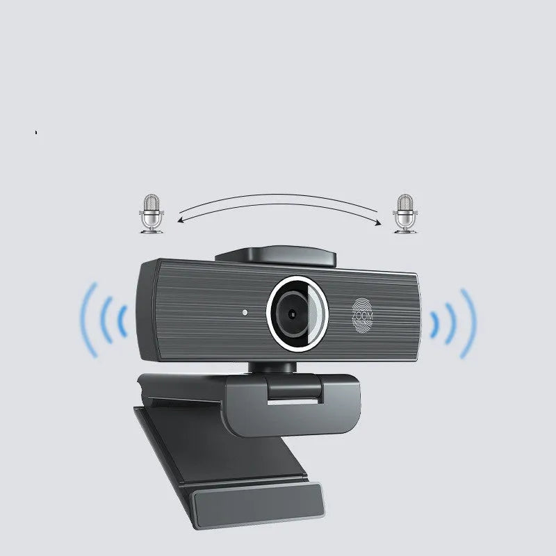 Matte black 4K USB webcam on a desk with a detached magnetic privacy cover and a long cable.