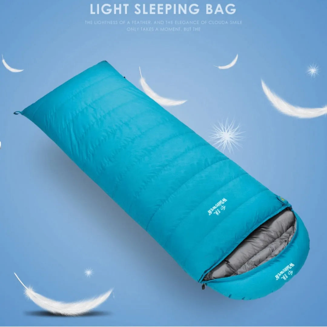Black outdoor sleeping bag with envelope structure and goose down fill on a campsite.
