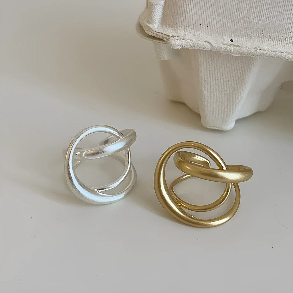 Geometric open ring with interlaced matte metal pattern in gold or silver electroplated finish