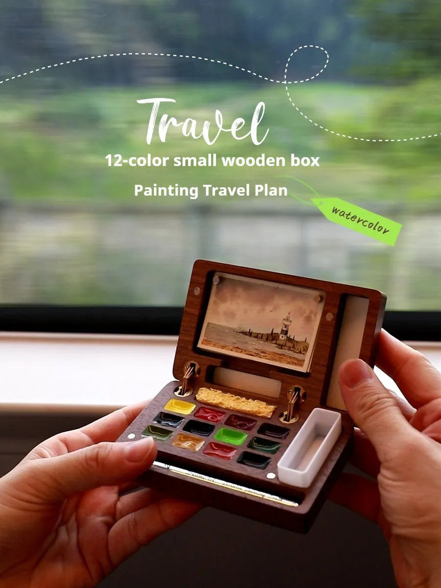 Mini walnut wood watercolour paint box open to show pigment pans inside