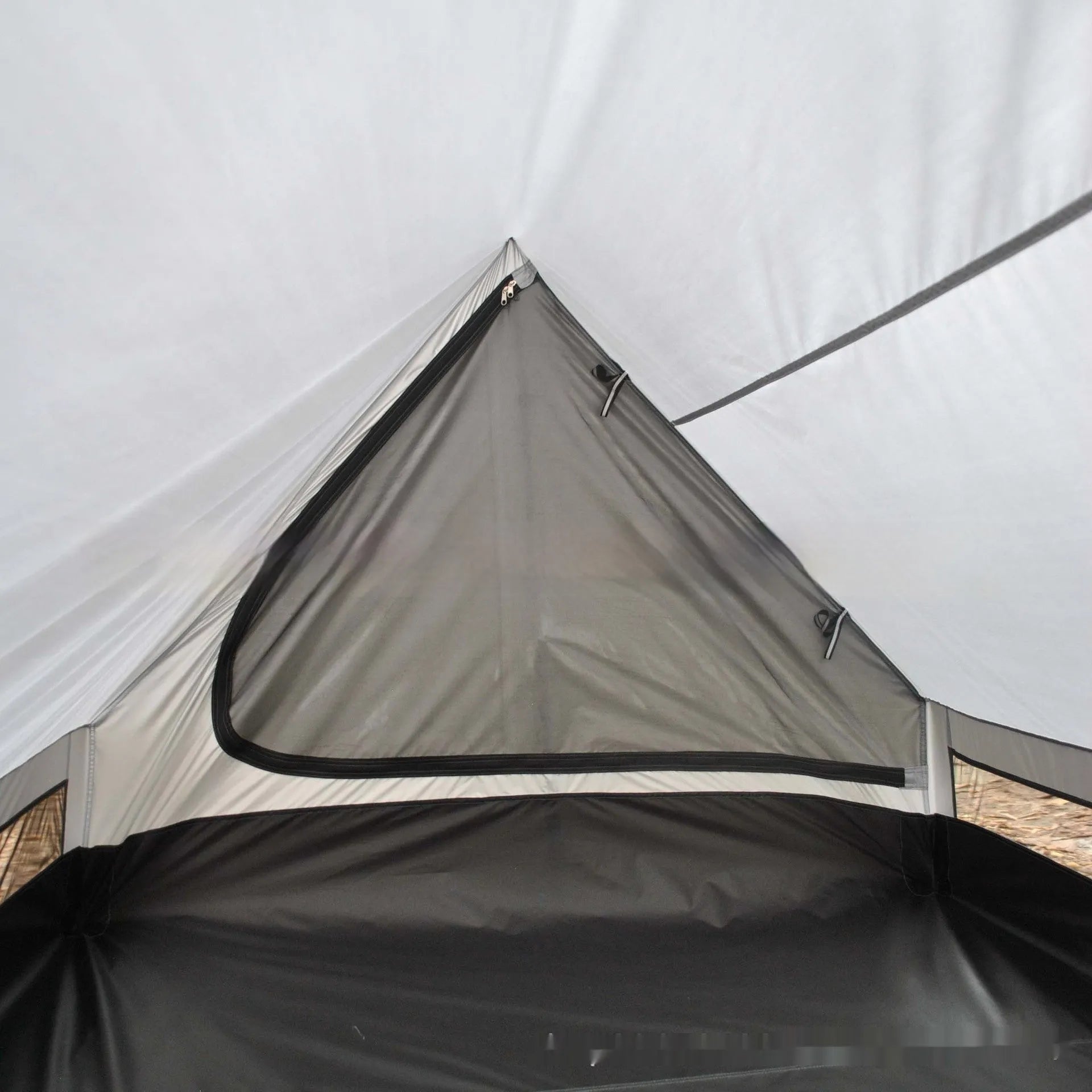 Brown A-line cabin tent setup with hiking pole supports showing spacious interior and waterproof fabric construction