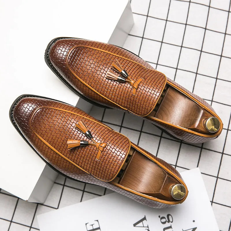 Men's black pointed slip-on shoe with a tassel on a business-style artificial PU upper.