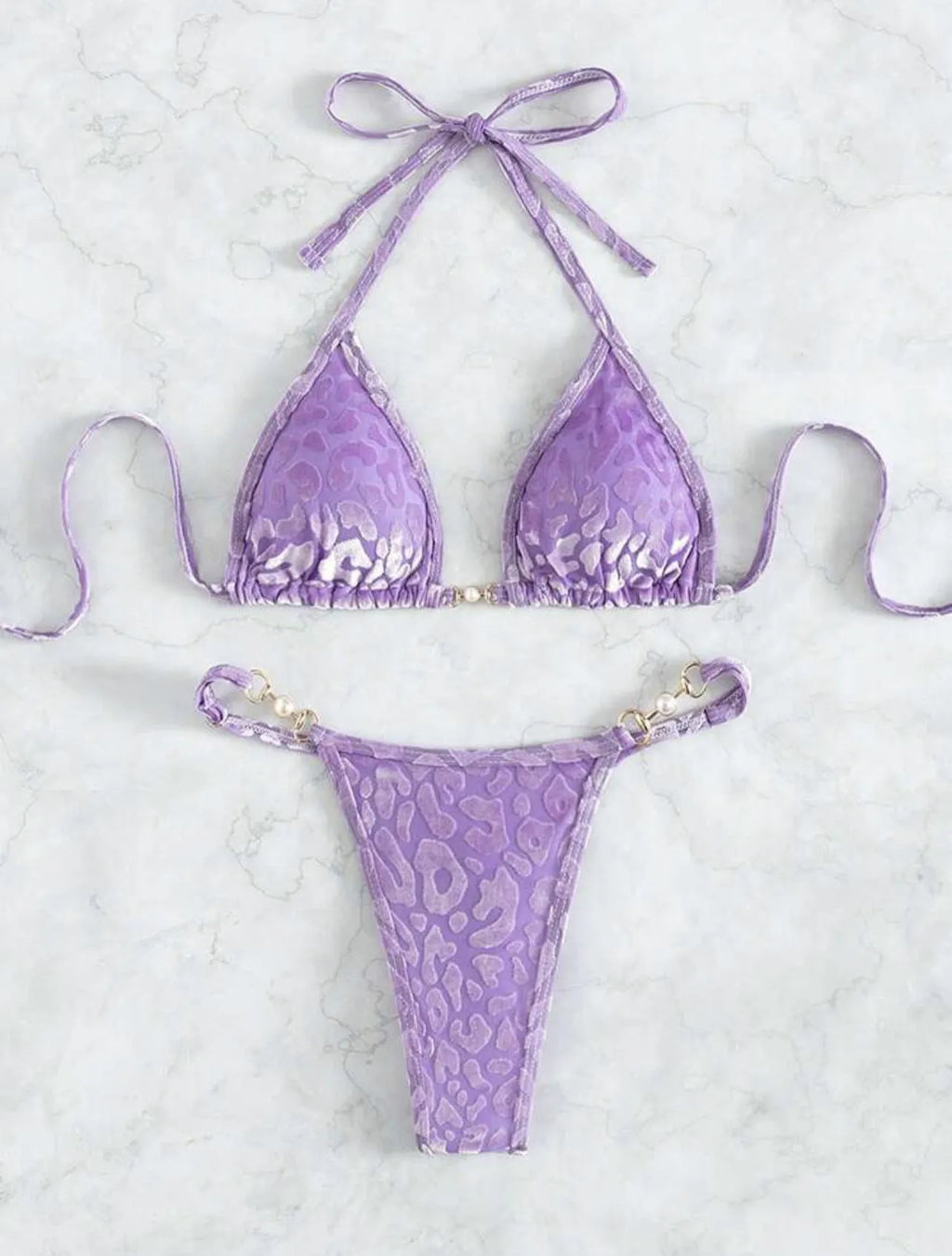 Blue and green leopard print women's bikini set on a mannequin, showing T-shaped design.