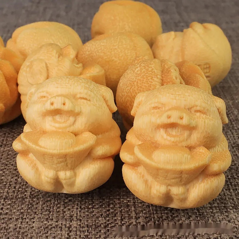 Solid bamboo carving pig ornament measuring 4cm height by 3.5cm diameter