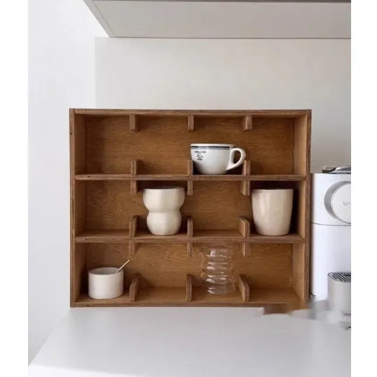 Square solid wood storage rack with multiple grid compartments for cups in a birch wood finish.