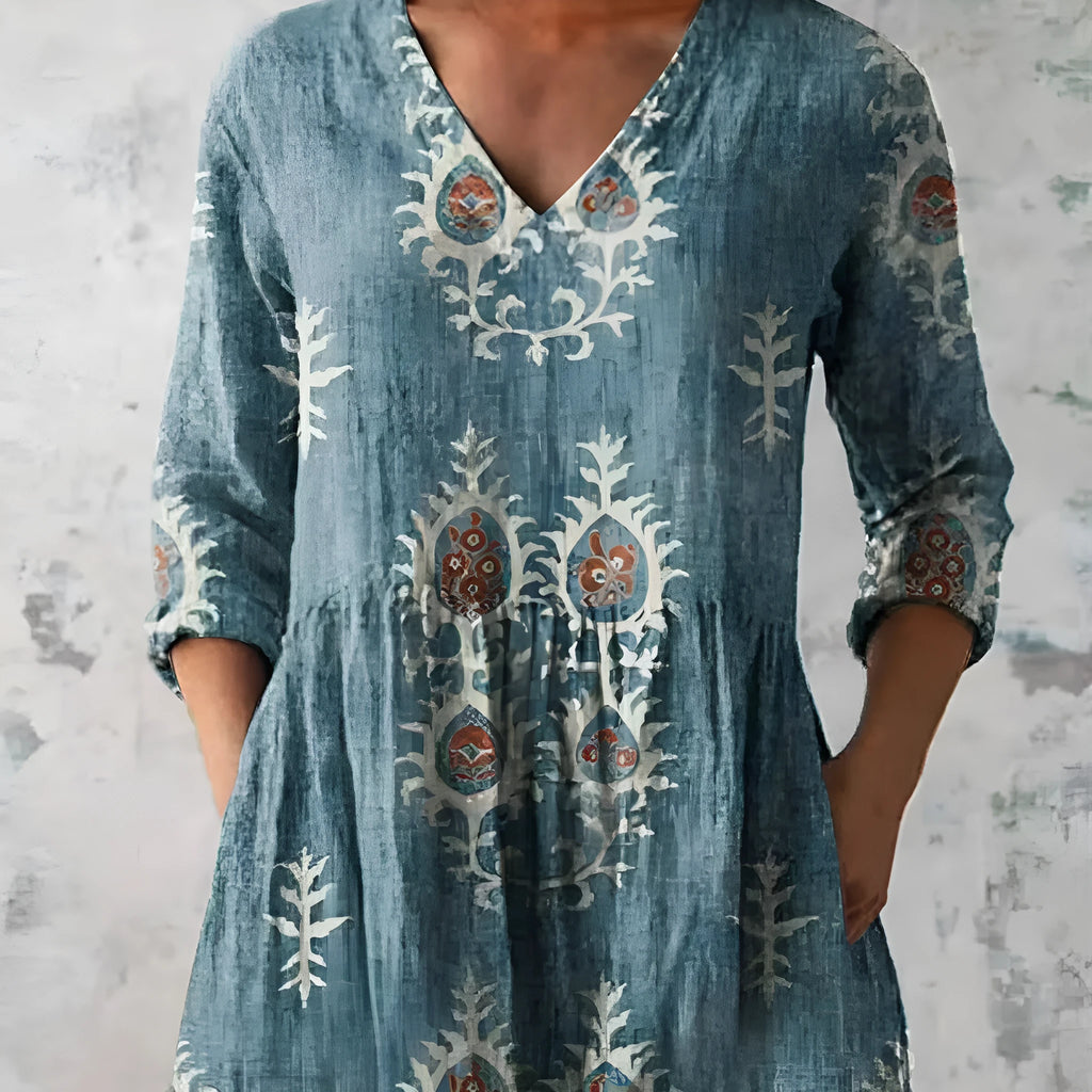 Women's floral printed loose dress with wide waist and three-quarter sleeves on a hanger.