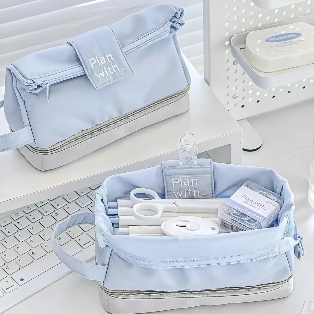 Dark blue folding double layer pencil case with internal compartments open to show organisation