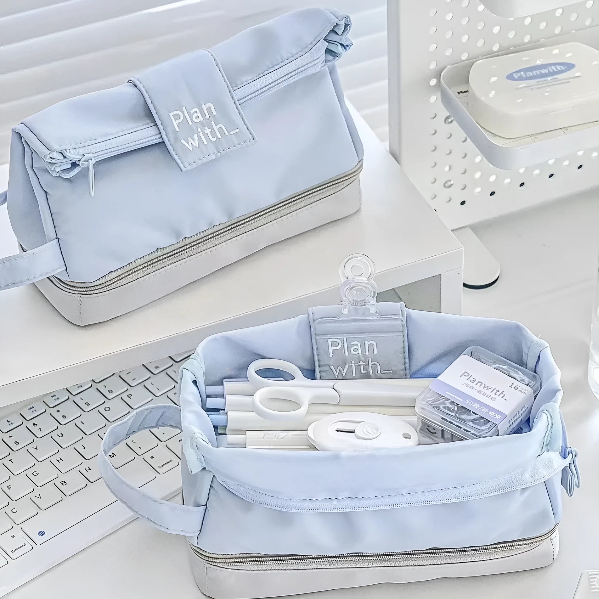 Dark blue folding double layer pencil case with internal compartments open to show organisation