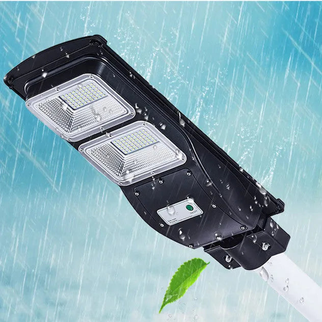 Integrated solar street light with 60W LED panel and remote control for outdoor pathway illumination.