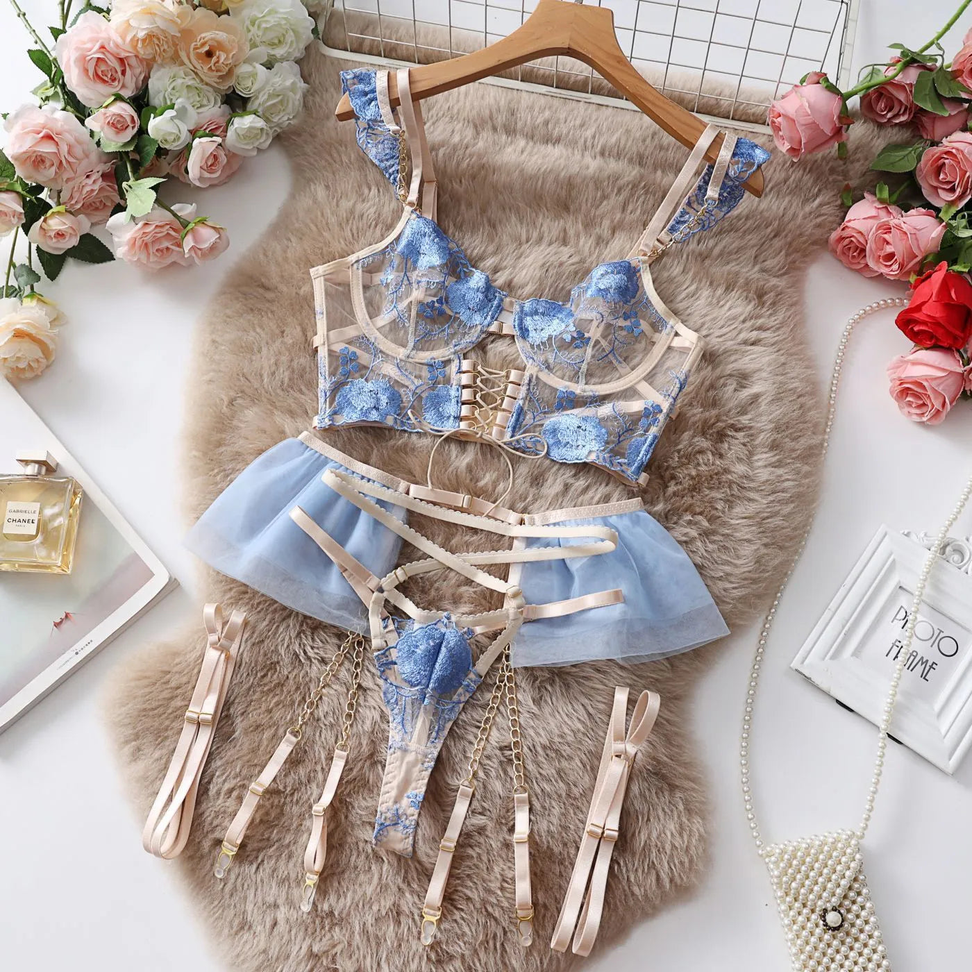 Light blue embroidered lace push-up bra and matching pants set on a mannequin.
