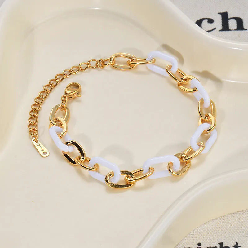 Stainless steel and resin bracelet for women with a double-layered heart-shaped charm.